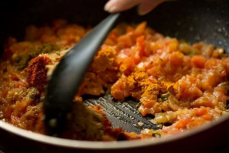 Add the spices and tomato